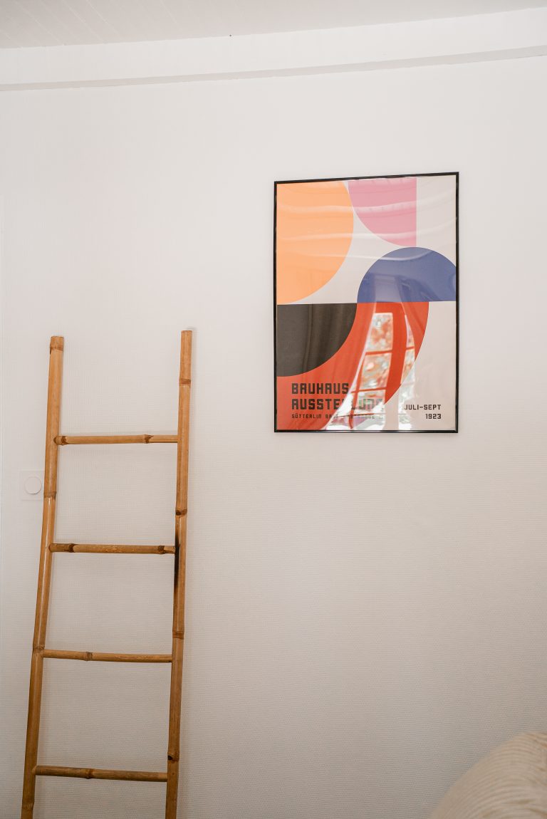 Décoration de la chambre 1 avec cadre mural et échelle en bambou servant de portant