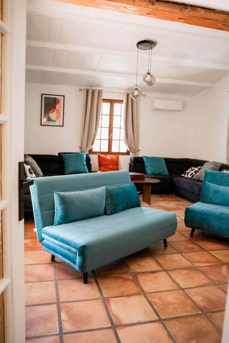 Salon spacieux avec deux canapés-lits et un grand canapé d’angle à la villa Ô Sud Location
