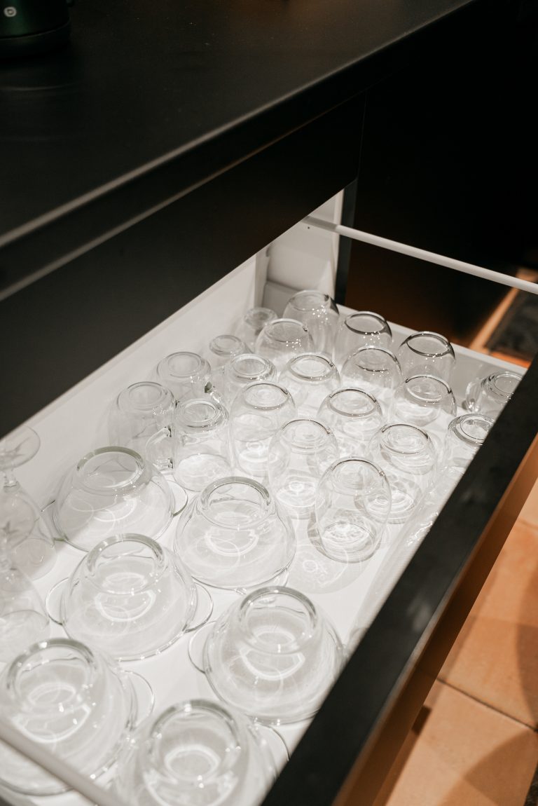Photographie mettant en avant un ensemble de couverts en acier inoxydable soigneusement rangés dans un support sur le plan de travail de la cuisine moderne de la villa Oléa. Les couverts reflètent la qualité et l’attention portée aux détails dans l’équipement de la cuisine, garantissant confort et praticité aux locataires pendant leur séjour.